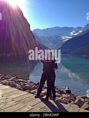 Lake Louise, Alberta, Kanada - 14. Oktober 2013 Touristen machen ein Selfie am Seeufer mit den felsigen Bergen im Hintergrund. Stockfoto