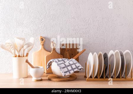 Stilvoller Küchenhintergrund mit einem Set verschiedener Küchenutensilien und -Utensilien aus umweltfreundlichen Materialien. Sauberes, gemütliches Haus. Stockfoto