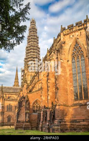 Blick nach Westen von der Rückseite der Lichfield Cathedral in Staffordshire, Großbritannien, mit Blick auf den hohen zentralen Turm, der während der Renovierung mit Gerüsten verkleidet ist Stockfoto