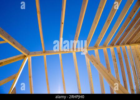 Bei der Konstruktion des Dachs in einer neuen Hauskonstruktion werden Stützbalken verwendet, um das Dach miteinander zu verbinden Stockfoto