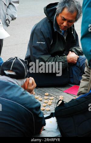 Ältere Männer genießen ein Spiel mit Xiangqi in San Francisco Stockfoto