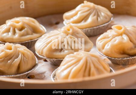 Chinesisches Essen Xiao Long Bao, kleines chinesisches gedämpftes Brötchen mit Hackfleisch, Tangbao (Suppenbrötchen) im Dampfgarer Stockfoto