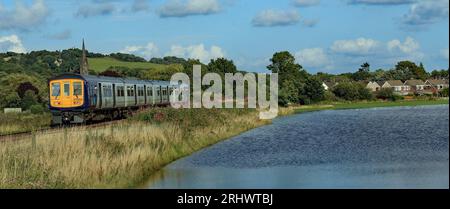 Nach einem nassen Wochenende überflutete der Fluss Douglas seine Ufer und überflutete ein Feld in der Nähe von Parbold, das von einem Zug zur Manchester Oxford Road geführt wird Stockfoto