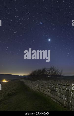 Hadrian's Wall under a starry night sky - looking west from Cawfield Crags. Stock Photo