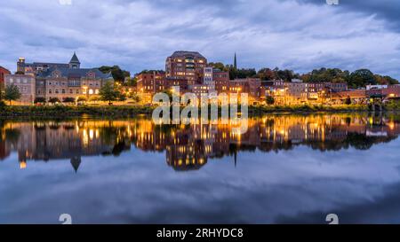 Downtown Augusta at Riverfront - A wide-angle view of Downtown Augusta at shore of Kennebec River on a stormy Autumn evening. Maine, USA. Stock Photo