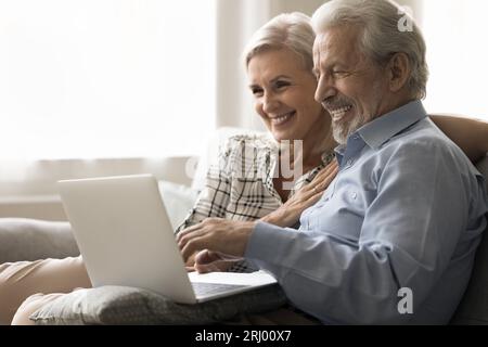 Glückliches älteres Ehepaar, das Freizeit und moderne Technik genießt Stockfoto