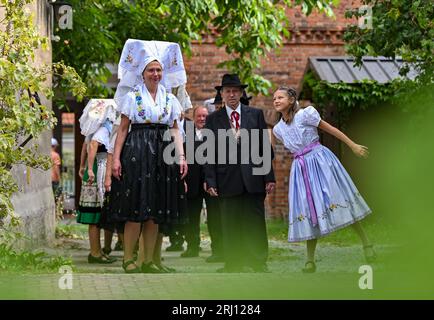 Burg, Deutschland. August 2023. Mitglieder der Heimat und Trachtenverein in Burg im Spreewald warten in sorbisch-wenischen Kostümen auf den Beginn des Gottesdienstes. Am Nachmittag findet die große Parade zum 29. Heimat- und Trachtenfest im Spreewald statt. Quelle: Patrick Pleul/dpa/Alamy Live News Stockfoto