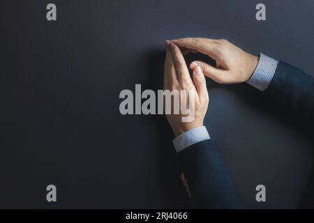 Ein Geschäftsmann legt seine Hände auf den Tisch, bereit, eine Entscheidung zu treffen Stockfoto