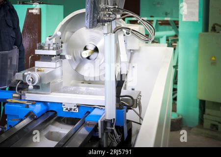 Große Tischdrehmaschine aus Metall, Reparaturausrüstung, Arbeiten mit Metall in der Werkstatt im Metallurgieanlagenwerk in der Reparaturproduktion. Stockfoto