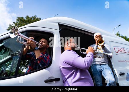 Edinburgh, Schottland, Großbritannien. August 2023. Musiker des Simón Bolívar Symphony Orchestra of Venezuela spielen heute von einem Bethany Care Van auf Leith Links. Die Musiker begleiten den Van auf seinen Runden und überraschen die Gäste des Auto-Van. Das Care Van Edinburgh bietet Obdachlosen und Menschen in Krisensituationen Nahrung und Unterstützung auf den Straßen von Edinburgh. Iain Masterton/Alamy Live News Stockfoto