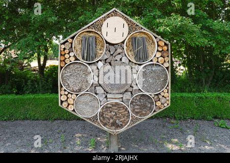 Large insect hotel in the shape of a hexagon on a sunny day. Stockfoto