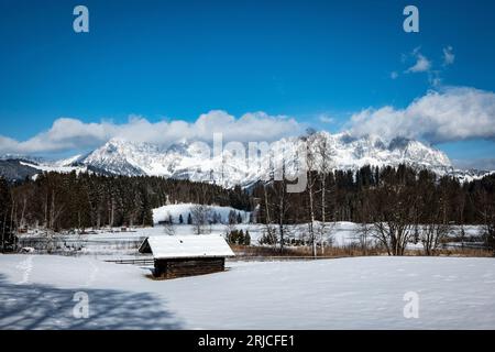 Eine wunderschöne Berglandschaft mit einer rustikalen Hütte, die mit Schnee bedeckt ist Stockfoto