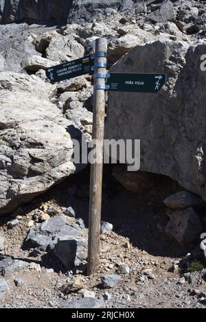 Signpost in the Picos de Europa, northern Spain, at a path junction, indicating Pena Vieja, Cabana Veronica and Horcados Rojos. Stock Photo