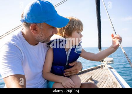 Vater und Sohn gemeinsam Tag draußen im Boot am Fluss Stockfoto