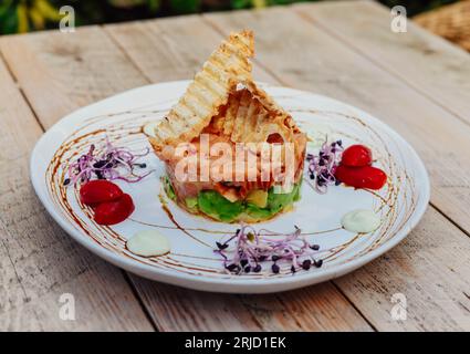 Salmon tartare with avocado and toasts ideal for summer Stock Photo