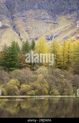 Herbstfarben auf Bäumen spiegeln sich in einem Loch an in Glencoe, Lochaber, Schottland, Großbritannien Stockfoto