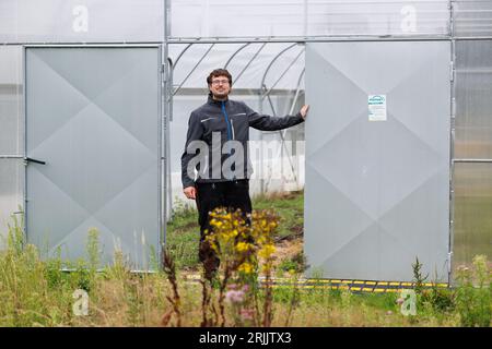 Bohmte, Deutschland. August 2023. Robert Franz, Gärtnermeister am DFKI, steht vor einem Gewächshaus. Das Deutsche Forschungszentrum für Künstliche Intelligenz (DFKI) betreibt Forschung und Entwicklung auf dem Gebiet der Agrarrobotik. Das DFKI testet auf einem ehemaligen Golfplatz bei Bohmte künstliche Intelligenz für die Landwirtschaft. (An dpa „Ein Trainingscamp für Roboter in der Landwirtschaft“) Credit: Frisch Gentsch/dpa/Alamy Live News Stockfoto