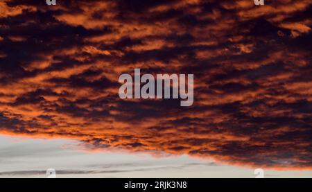 dramatic Red clouds for pattern background. A burning sky in a horror movie. crimson storm in apocalyptic, judgment day. Stock Photo