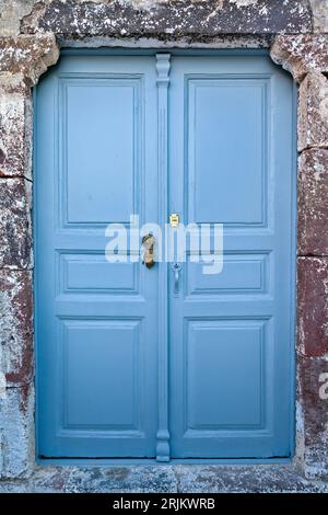 Beautiful light blue, wooden door of an old mansion at the traditional village of Pyrgos Kallistis, in Santorini island, Cyclades, Greece, Europe. Stock Photo