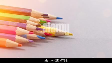 Bunch of color pencils ready to be use. School stuff concept. Shellow DOF, focus on yellow pencil in foreground. Stock Photo