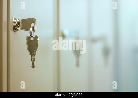 Group of closed doors with keys in the door lock. Keys in the keyhole. Stockfoto