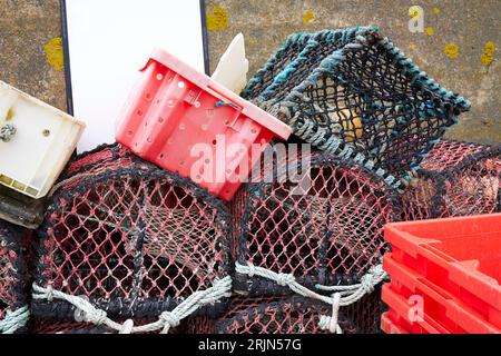 A group of lobster traps and several plastic containers Stock Photo