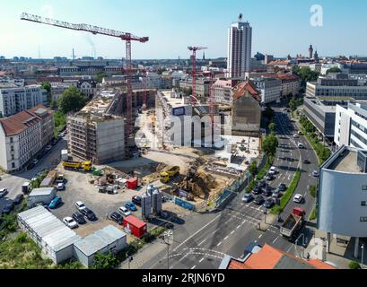 Leipzig, Deutschland. August 2023. Mehrere Krane befinden sich auf der Baustelle des Krystallpalastgebietes (Luftaufnahme mit Drohne). Auf dem rund 18.000 Quadratmeter großen Brachfeld in der Nähe des Stadtzentrums entsteht ein neuer Gebäudekomplex mit vier 4-6 Etagen und einem öffentlichen Innenhof. Das neue Quartier mit Büros, Hotel und Apartments auf dem historischen Gelände am Leipziger Hauptbahnhof soll bis 2025 fertiggestellt werden. Quelle: Jan Woitas/dpa/Alamy Live News Stockfoto