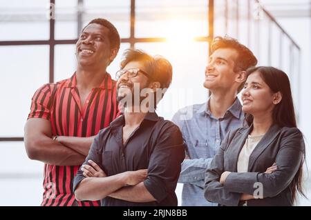 Work hard but stay humble. A group of people look away in an office corridor. Stockfoto