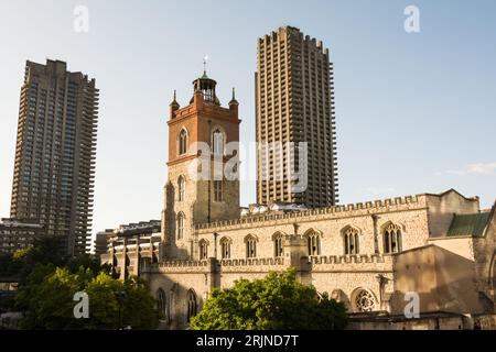 The tower of St Giles-without-Cripplegate in the City of London dwarfed by modern highrise sykscrapers on the Barbican Estate, London, England, U.K. Stock Photo