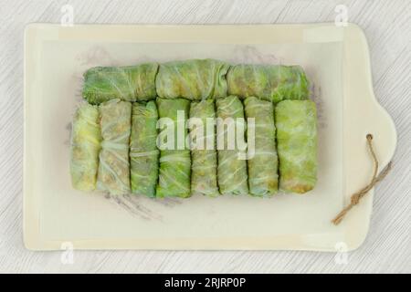 Frozen doves on a ceramic tray. Stuffed cabbage rolls are frozen. Top view. Stock Photo