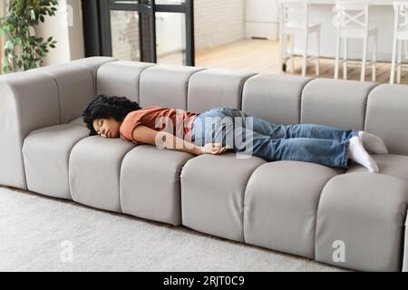Körperliche Erschöpfung. Müde Afroamerikanische Frau, Die Zu Hause Auf Dem Sofa Schläft Stockfoto