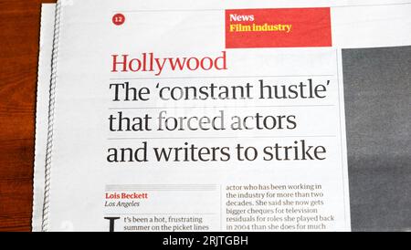 'Hollywood The 'constant hustle' that forced actors and writers to strike' Guardian newspaper headline article14 July 2023 London England UK Stock Photo