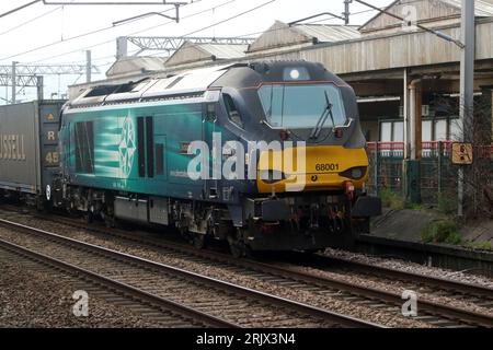 Direct Rail Services class 68, 68001 Evolution, passing Carnforth on West Coast Main Line, 23rd August 2023 with container train. Stock Photo