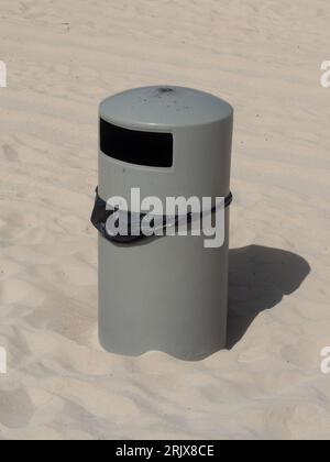 Litter bin on a clean sandy beach.  Visitors put their rubbish away Stock Photo