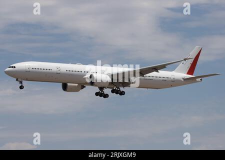 A Boeing 777 lands at Phoenix Sky Harbor Airport.  This plane is being transported to a new owner in another country . Stock Photo