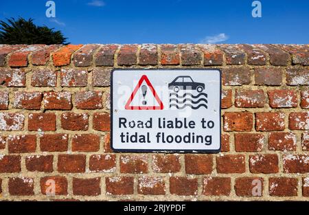 Sign at Bosham, a coastal village on the south coast near Chichester, West Sussex, southern England warning that the road is liable to tidal flooding Stock Photo