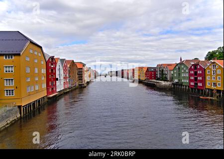 Historic old wooden and houses with colorful facades over the river Nidelva in the Brygge district, in the scenic Scandinavian city of Trondheim Stock Photo