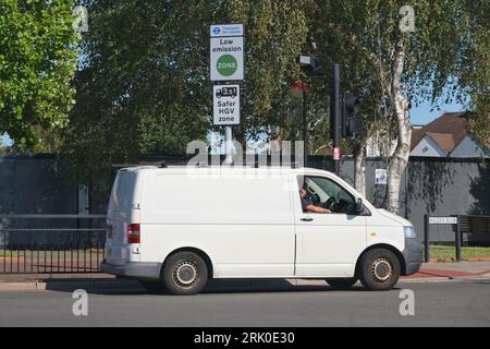 London, UK. A tradesperson's van passes a Low Emission Zone (LEZ) road sign in south-west London. Stock Photo