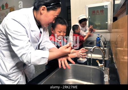 Bildnummer: 53153254 Datum: 08.04.2009 Copyright: imago/Xinhua Ein medizinischer Mitarbeiter überprüft den Mund eines Jungen im Xinghai Kindergarten in der Stadt Hebi, Provinz Henan in Zentralchina, 8. April 2009. In den Kindergärten von Hebi werden vor kurzem Vorsorgemaßnahmen durchgeführt, um die Maul- und Klauenseuche (HFMD) bei Kindern zu verhindern. Kbdig einer medizinische Arbeiterin prüft einer Boy s Mund im Xinghai Kindergarten in der Stadt Hebi, Provinz Henan in Zentralchina, Krankheit (HFMD) Gesundheit, Maul-und-Klauenseuche, Untersuchung quer Bildnummer 53153254 Datum 08 04 2009 Copyright Imago XINHUA A Medical W Stockfoto