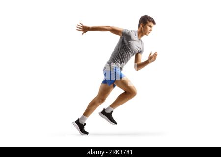 Full length profile shot of a fit male teenager running isolated on white background Stock Photo