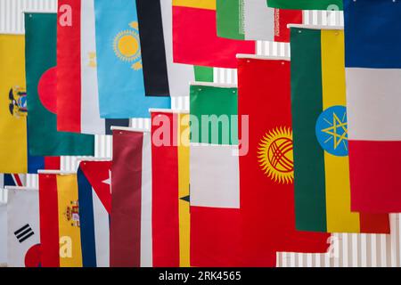 Colorful national flags of various countries hanging in row on street in Haifa Israel Stockfoto