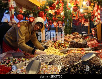 Bildnummer: 53664098  Datum: 13.12.2009  Copyright: imago/Xinhua (091214) -- LONDON, Dec. 14, 2009 (Xinhua) -- A salesman arranges candies in his stall at a Christmas market near the River Thames in London, capital of Britain, Dec. 13, 2009. The annual Christmas market, usually between the end of November and the beginning of next January, serves a popular destination for Londoners as it offers variety of Christmas nicknacks, snacks and entertainments. (Xinhua/An Zhiping) (lmz) (5)BRITAIN-LONDON-CHRISTMAS MARKET PUBLICATIONxNOTxINxCHN England London Weihnachtsmarkt Weihnachten kbdig xcb 2009 q Stockfoto