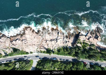 Aerial view of a pristine highway winding along the coast, leading to the horizon Stock Photo