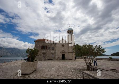 Our Lady of the Rocks is one of the two islets off the coast of Perast in the Bay of Kotor, Montenegro (the other being Sveti Đorđe island). It is an Stock Photo