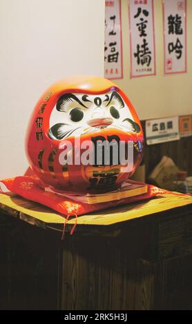 A closeup shot of a traditional Japanese Daruma doll. Stock Photo