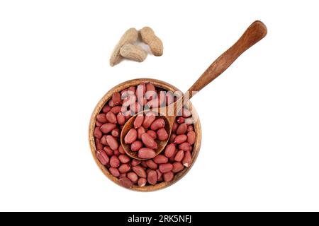 Top view of a wooden spoon with peanuts in on nuts in a bowl. Copy space. Stockfoto
