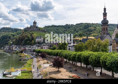 A scenic view of the green bank of Moselle River with Cochem castle in the background. Germany. Stock Photo