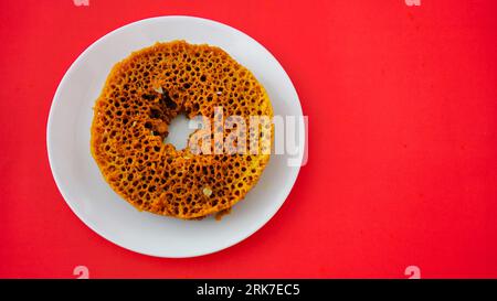 Indian Rajasthani crunchy sweet dish called Ghevar or Ghewar is an made using refined flour, sugar, and ghee. Generally prepared in festive season of Stock Photo