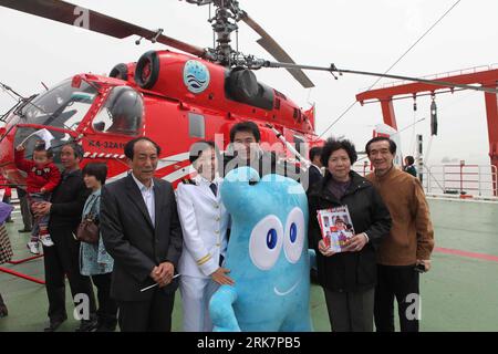 (100411) -- SHANGHAI, April 11, 2010 (Xinhua) -- People pose for a group photo with Haibao, the mascot of the 2010 Shanghai World Expo, aboard the Xuelong (Snow Dragon) icebreaker upon its arrival at the harbour of Shanghai, east China, April 10, 2010. China s 26th Antarctic expedition team aboard the Xuelong (Snow Dragon) icebreaker return to its base in Shanghai Saturday morning after finishing 12 scientific research projects covering remote sensing, icebergs, biology, physics, etc. This expedition had the biggest staff since China started Antarctic missions in 1984. The 249 staff completed Stock Photo