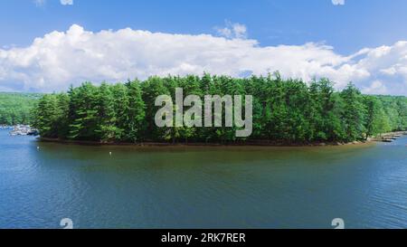 An aerial view of Deep Creek Lake in Maryland, USA, with a small island in the center with pine trees Stock Photo